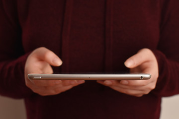 Female person holding tablet in hands