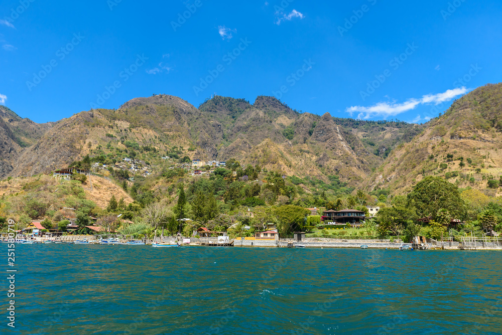 Wall mural shore of santa cruz la laguna at lake atitlan in vulcano landscape of guatemala