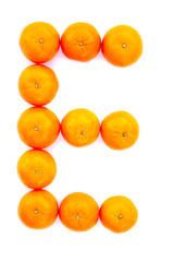 Letter solved with tangerines isolated on white background. Mandarine «E» letter