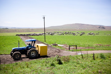 A tractor doing some heavy work on a farm.