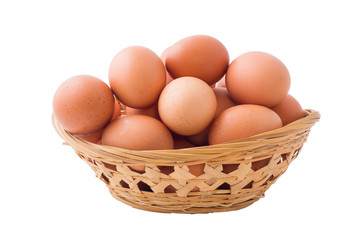 Chicken eggs in basket on isolated white background.