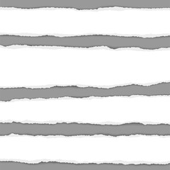 Several vector torn white paper stripes with shadow placed on gray background. Realistic ripped paper pieces.