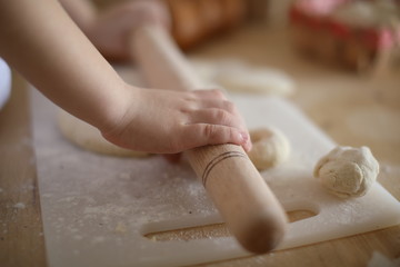 in the kitchen the baby rolls and plays with the dough and make pizza and bread