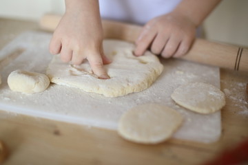in the kitchen the baby rolls and plays with the dough and make pizza and bread