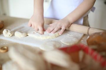 in the kitchen the baby rolls and plays with the dough and make pizza and bread