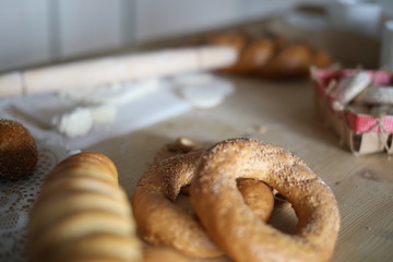 bread, rolls and bagels are on the table