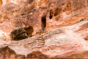 Cave and stairs to cave in the rock in the city of Petra, Jordan. Petra is a historical and archaeological city in southern Jordan.