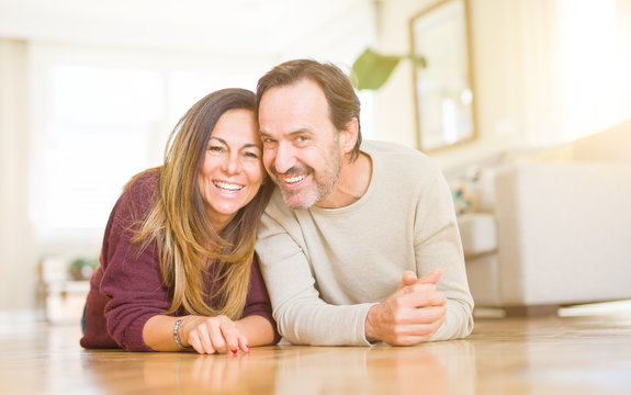 Beautiful romantic couple sitting together on the floor at home