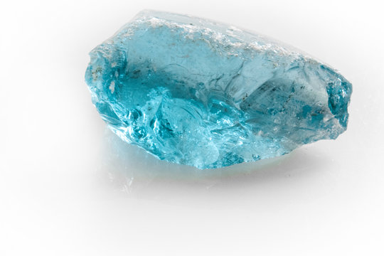 raw blue topaz gem on white background