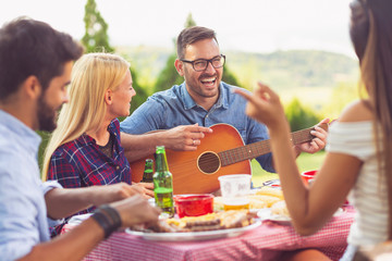 Playing guitar at a barbecue party