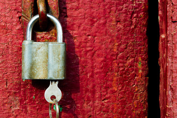 Lock with a key on the background of the old door