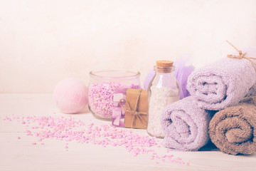 Obraz na płótnie Canvas Bath salt, towel, sponge on a gentle purple background. Beauty and body care concept. Selective focus. Horizontal frame.