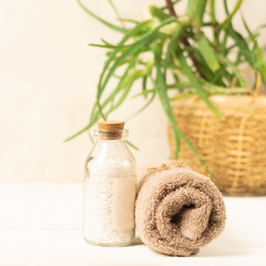 Obraz na płótnie Canvas A set of items for the spa procedures. Bath salt, towel on a light background Beauty and body care concept.