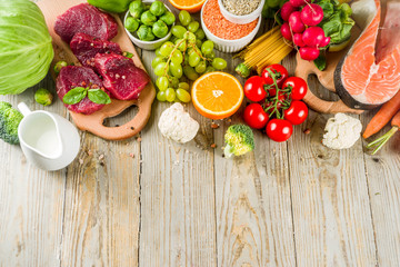 Flexitarian diet diet, with fresh vegetables, raw meat and fish, legumes, grains, fruit, wooden background, copy space top view