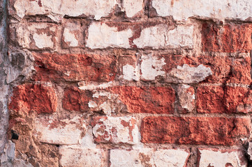 Background from old cracked bricks with shabby tiles