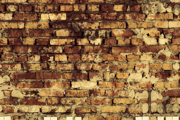 old bare wall with dirty cracked brickwork of brown bricks