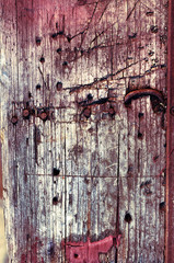Background of old grungy wooden timber with protruding rusty nails.