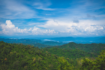 Fototapeta na wymiar Blue sky high peak mountains fog hills mist scenery river lake dam bay gulf wildlife National park views Kanchanaburi, Thailand.