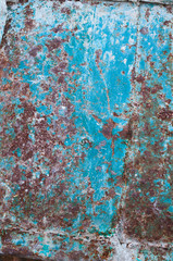 background from an old rusty sheet of metal with faded shabby peeling blue paint