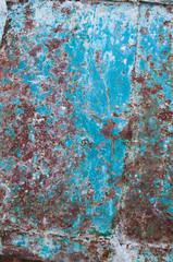 background from an old rusty sheet of metal with faded shabby peeling blue paint