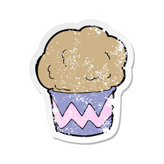retro distressed sticker of a cartoon cupcake