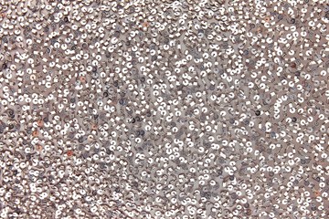 Fototapeta premium Fabric with sequins and sequins of bright colors. Fashion glitter fabric, sequins. Shiny surface