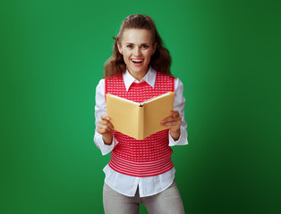 happy healthy student woman holding opened yellow book