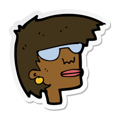 sticker of a cartoon female face with glasses