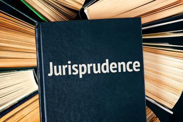 Old hardback books with book Jurisprudence on top.
