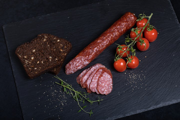 Salami on black stone plate