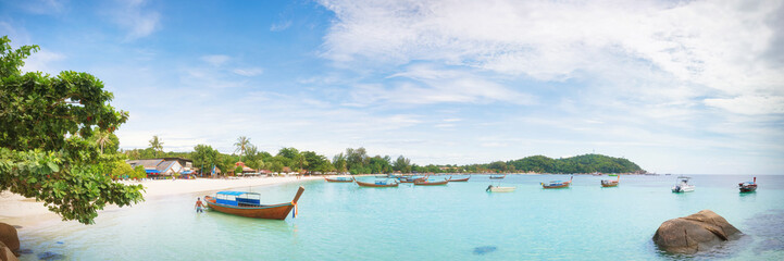 Panorama of Koh Lipe Sunset Beach with water on foreground