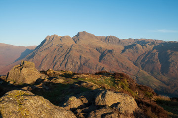 Fototapeta na wymiar First light on the Langdale Pikes from Side Pike, Lake District, UK