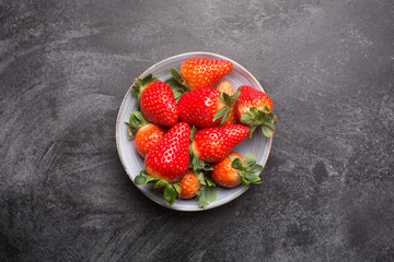 Fresh spanish strawberries in a bowl on a rustic table