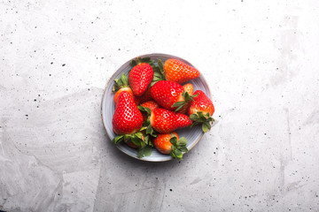 Fresh spanish strawberries in a bowl on a rustic table