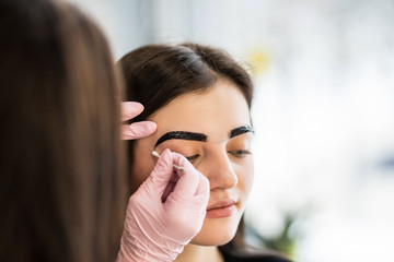 Young woman having brow color added to her eyebrows