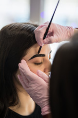 Young woman having brow color added to her eyebrows