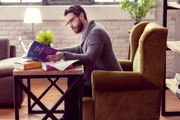 Nice handsome man looking into the book