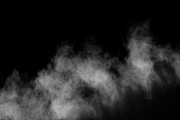 White powder explosion cloud against black background.White dust particles splash.