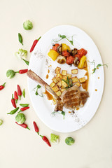 lamb leg with baked potatoes and herbs