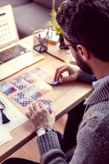 Fototapeta na wymiar Professional smart male fortuneteller using tarot cards