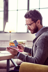 Serious thoughtful man reading the meaning of the card