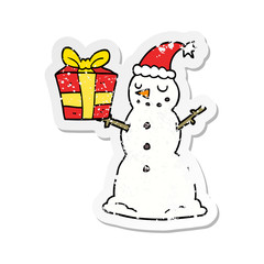 distressed sticker of a cartoon snowman with present