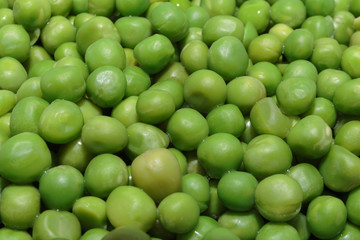 Heap of fresh green peas close-up. Concept of vegan food or natural background.