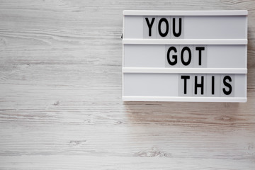 Modern board with 'You got this' words over white wooden surface. Business concept. Overhead, top...