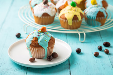 Colorful glazed muffins for kids party