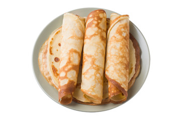 Thin pancakes on a plate isolated on a white background.