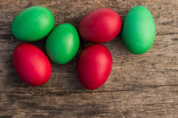 Painted Easter eggs on rustic wooden background