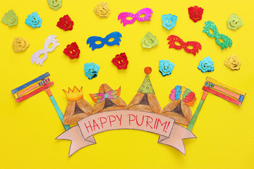 Purim celebration concept (jewish carnival holiday). Traditional hamantash cookies cutted from paper and painted