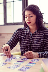 Fototapeta premium Serious good looking woman focusing on her work