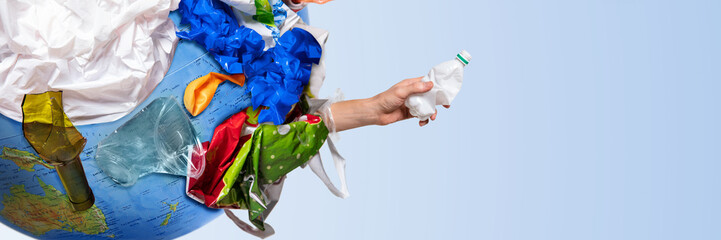 An earth globe covered with trash and male hand squeezing plastic bottle over white background, the concept of ecology problem and World Environment Day. Photo with message for social advertising